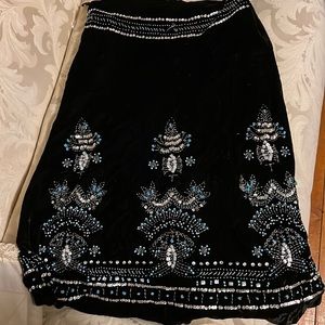 Long black skirt with design at the bottom of it